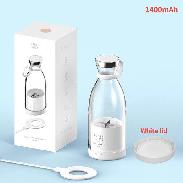 Clear water portable blender with white lid and packaging on a light blue background