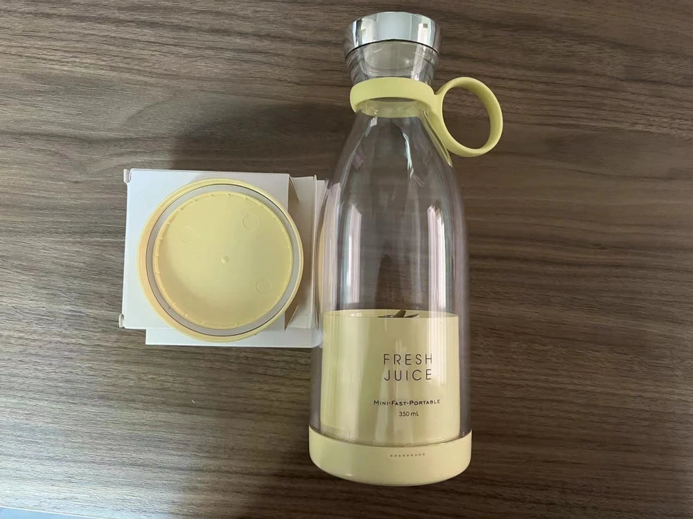 Cream yellow Fresh Juice portable blender 350ml with lid removed – flat lay on wooden surface
